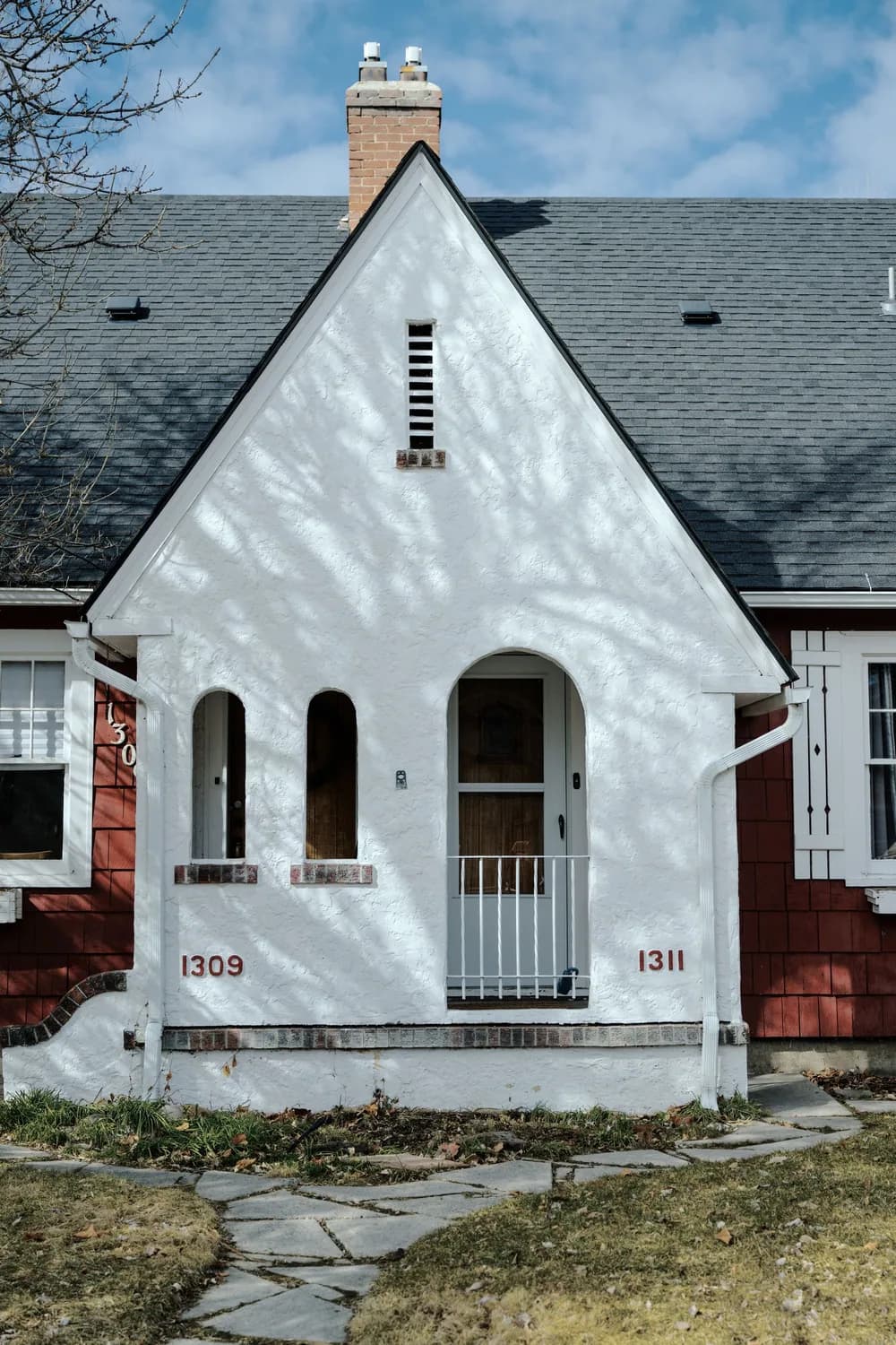 An older house with a front porch and an arched doorway