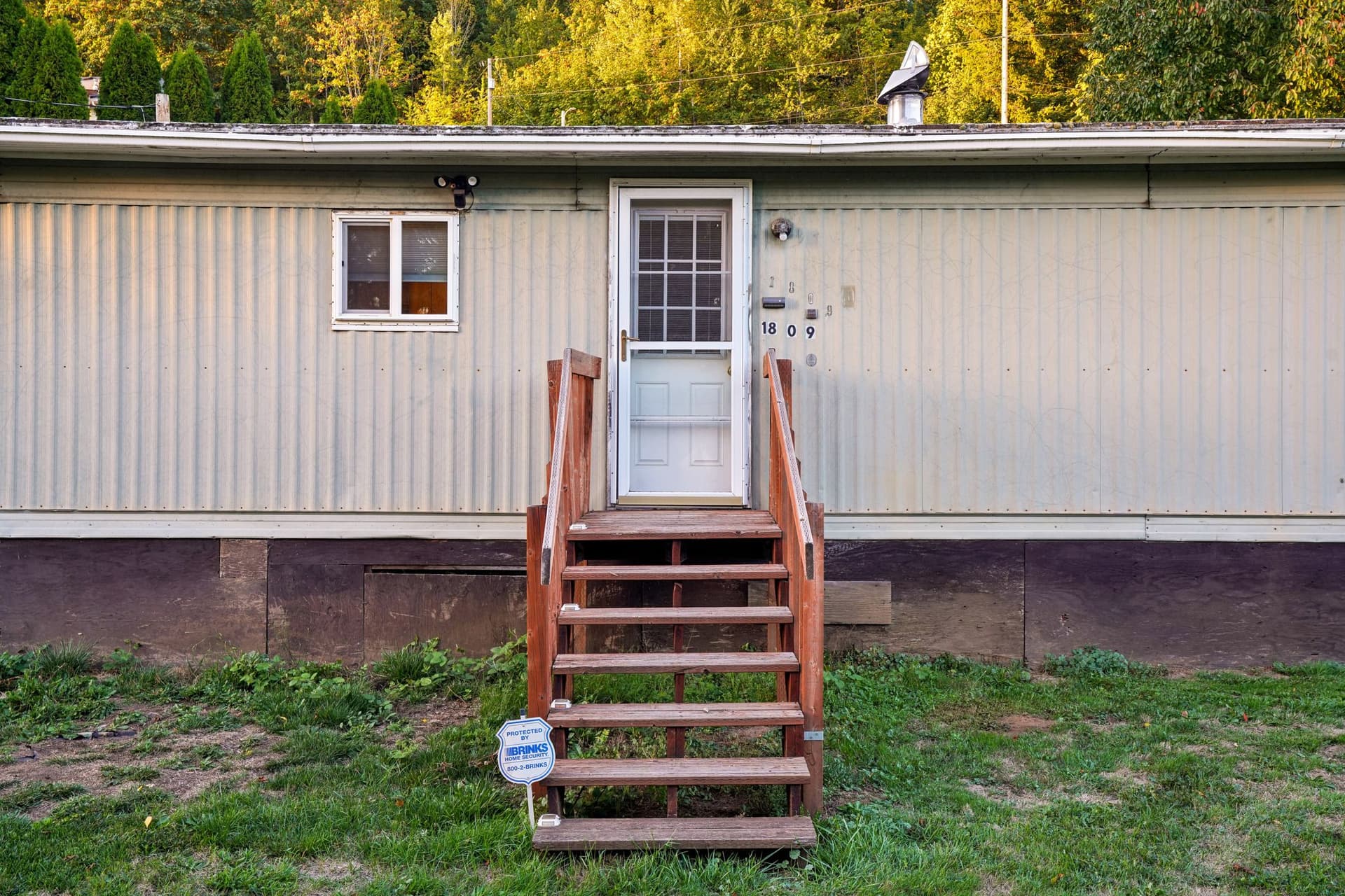 Manufactured home exterior with wooden entry steps