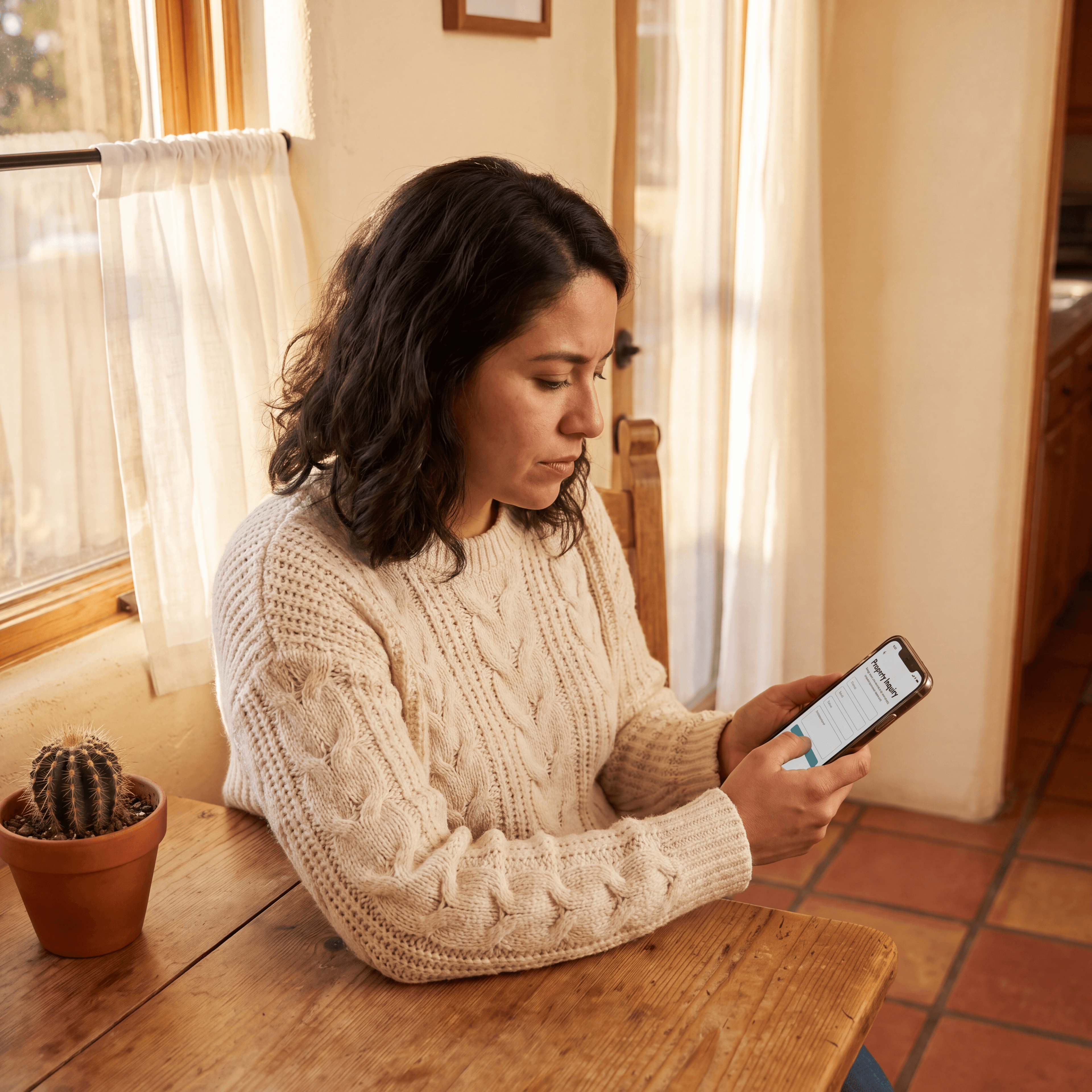 Homeowner submitting property details online for a cash offer